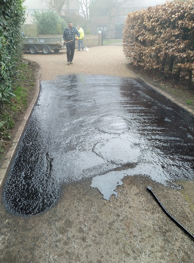 this is a photo of a tar and chip driveway being constructed