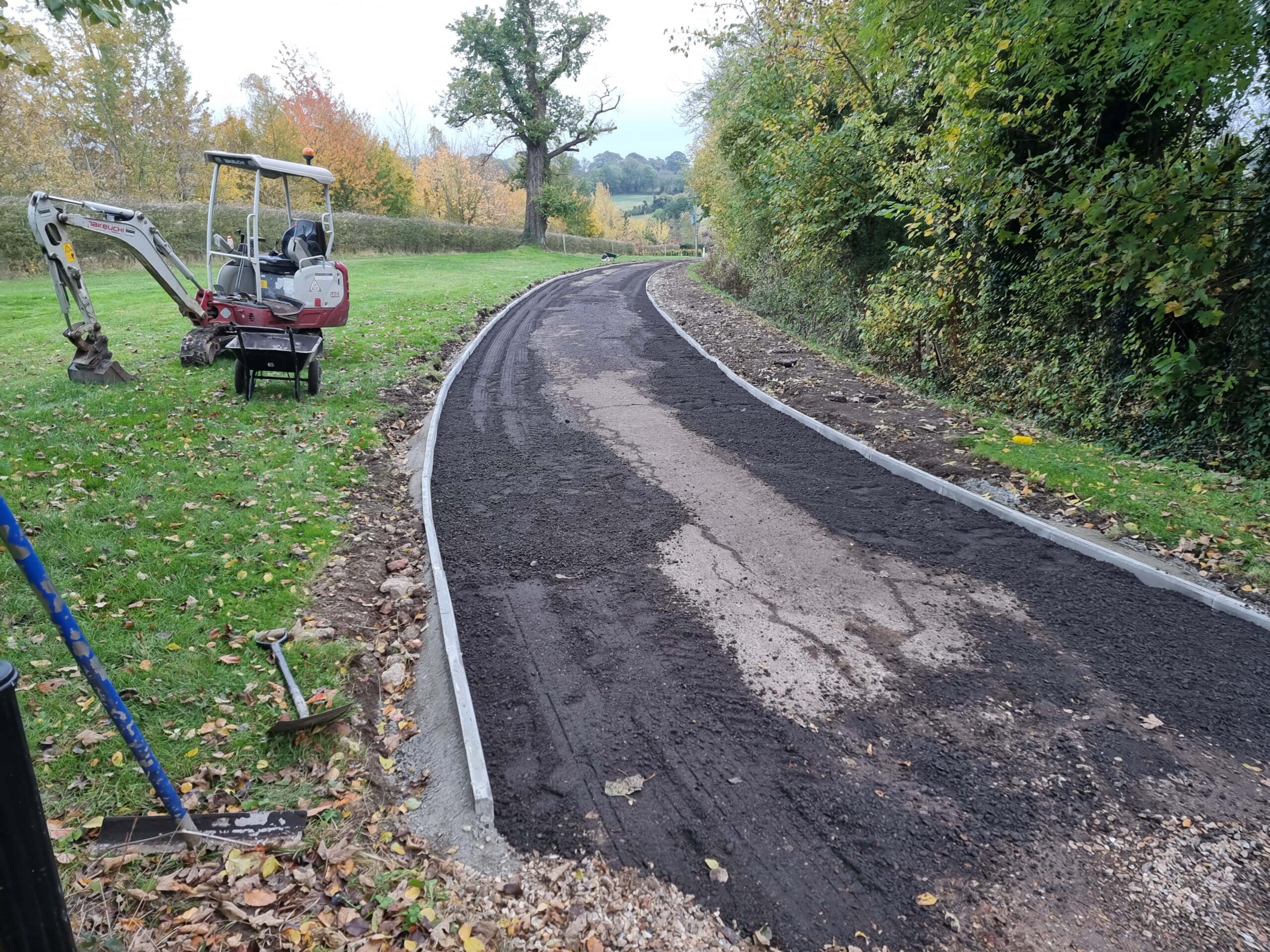 this is a photo of a tar and chip driveway being constructed